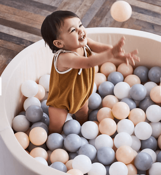 Collapsible children's ball pit with neutral tones for nursery play area